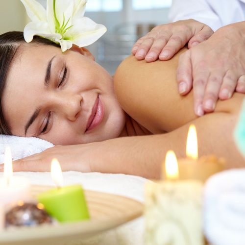 Portrait of young female enjoying the procedure of massage